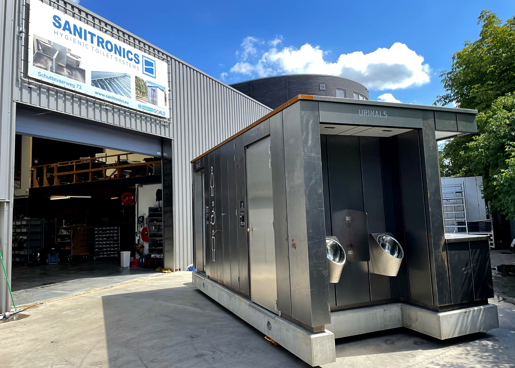 Urinal on the outside of the Revolving Toilet at the workplace + shower combination.
